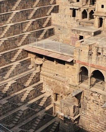 Flights of steps zigzagging down the walls of an ancient stone stepwell